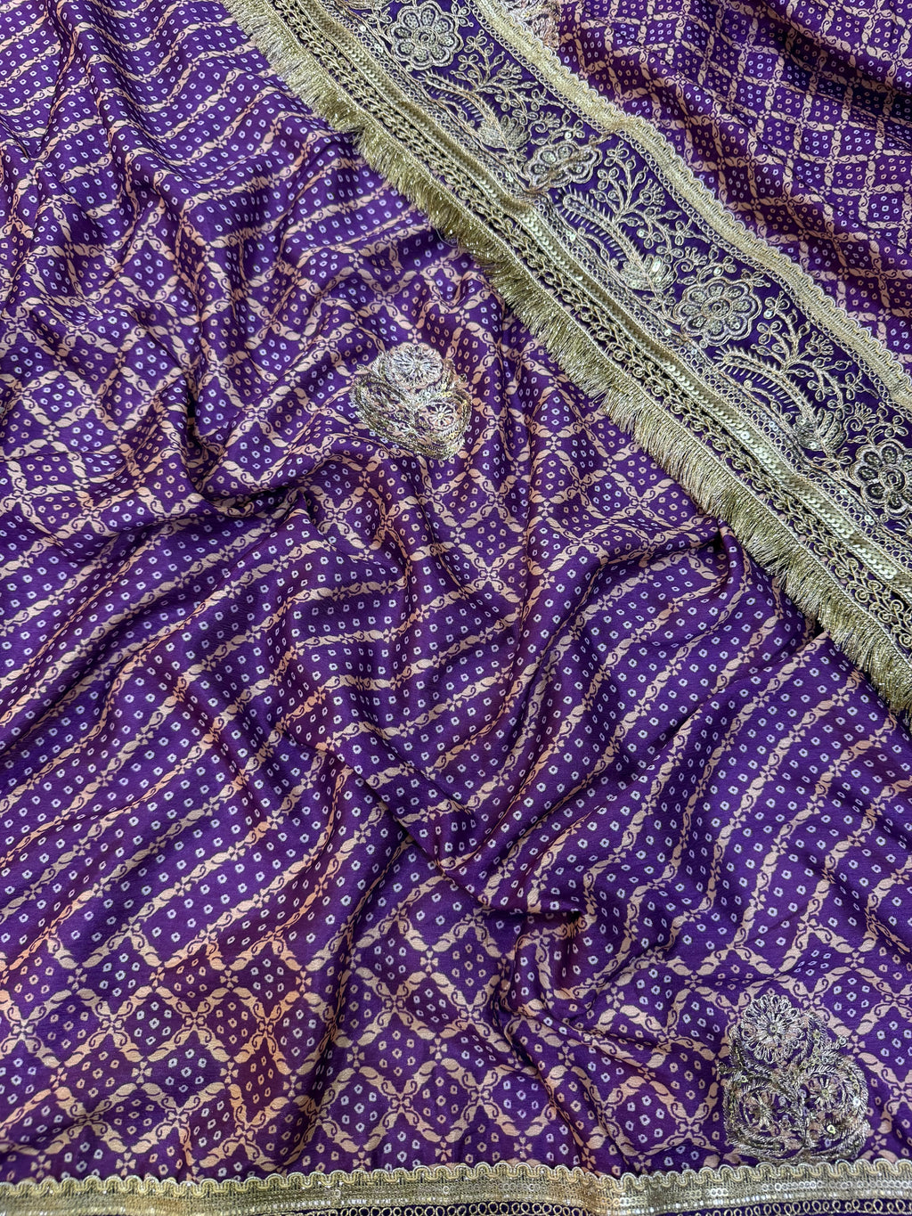 Royal Purple Bandhani-Style Printed Saree with Intricate Golden Embroidered Border & Tassel Detailing